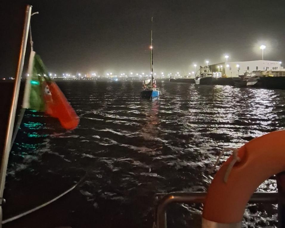 veleiro à deriva rebocado para o porto de pesca costeira.